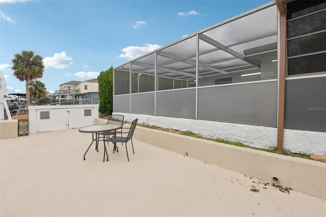 a living room with couches and kitchen view with wooden floor