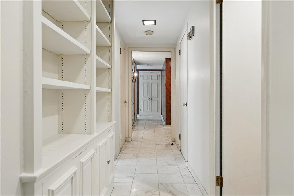 5048 Fifth Avenue, Unit 101 Pittsburgh, PA 15232 - Photo 18 of 24 a view of a hallway with wooden shelves