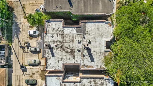 an aerial view of residential houses with outdoor space and street view