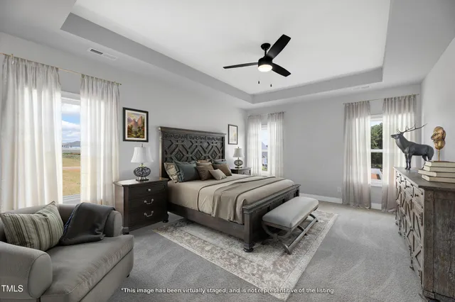 a bedroom with a bed a couch and a large window