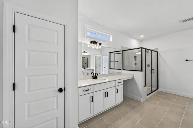 a bathroom with a granite countertop sink a mirror and a vanity