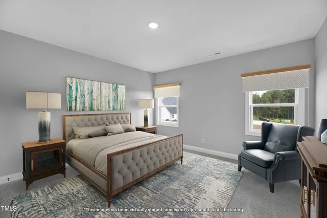 a bedroom with a bed and a couch next to a window