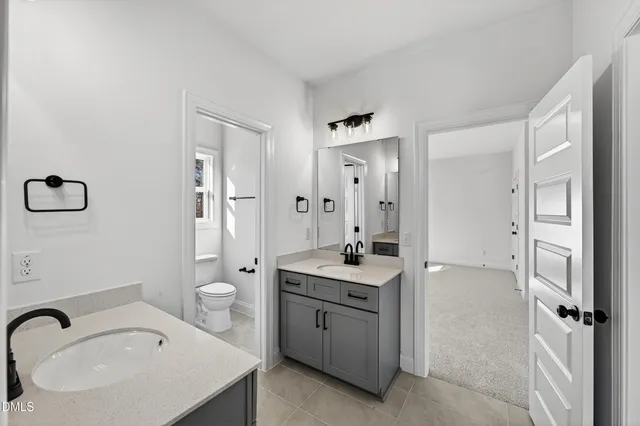 a spacious bathroom with a granite countertop sink toilet and shower