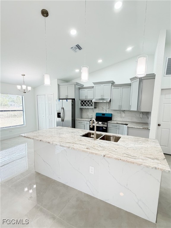 2800 46th Street Southwest Lehigh Acres, FL 33976 - Photo 8 of 15 a kitchen with kitchen island a sink stainless steel appliances and white cabinets