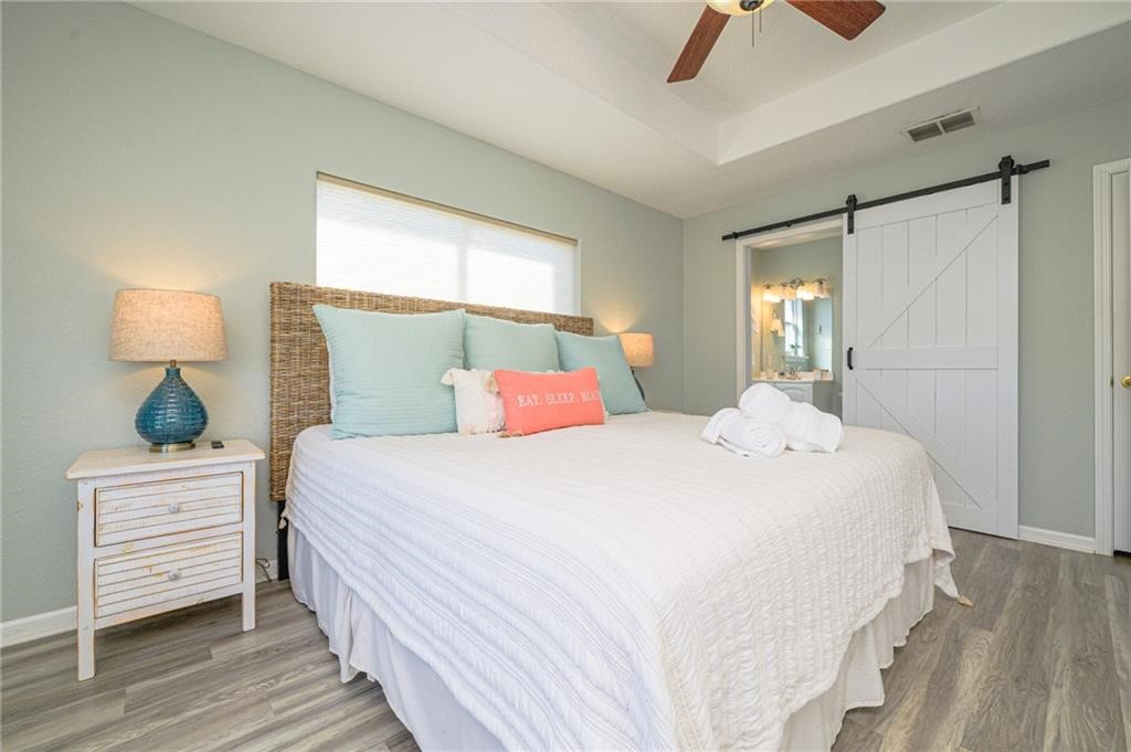 102 Ball Street Rockport, TX 78382 - Photo 13 of 40 a bedroom with a bed a window and lamp