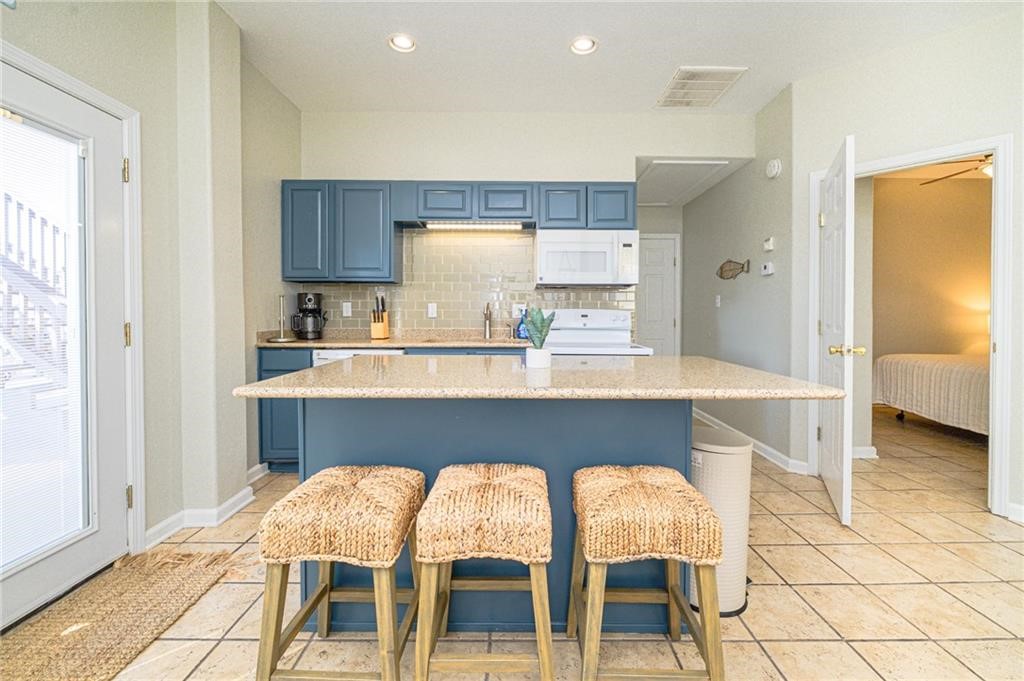 102 Ball Street Rockport, TX 78382 - Photo 20 of 40 a kitchen with a table chairs sink and cabinets