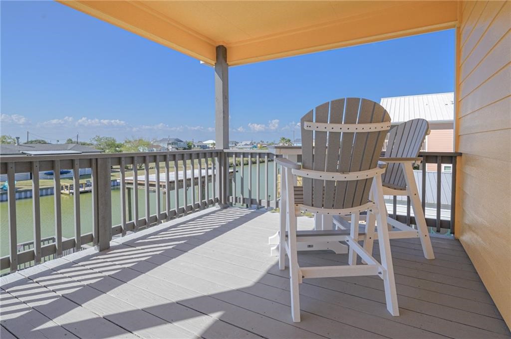 102 Ball Street Rockport, TX 78382 - Photo 26 of 40 a view of balcony with wooden floor and outdoor seating