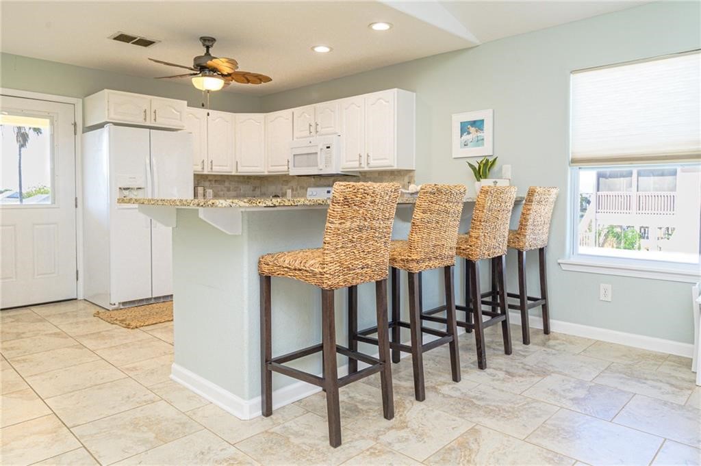 102 Ball Street Rockport, TX 78382 - Photo 9 of 40 a view of a dining room with furniture and a chandelier
