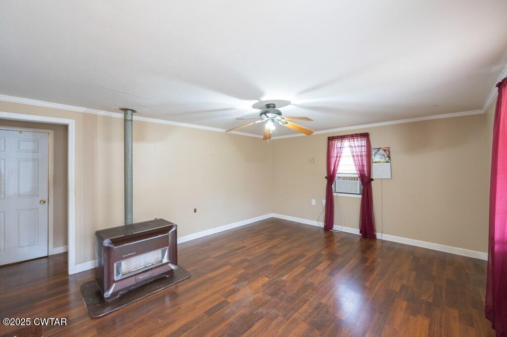 8405 Highway 77 Huntingdon, TN 38344 - Photo 11 of 37 a view of an empty room with wooden floor and a window