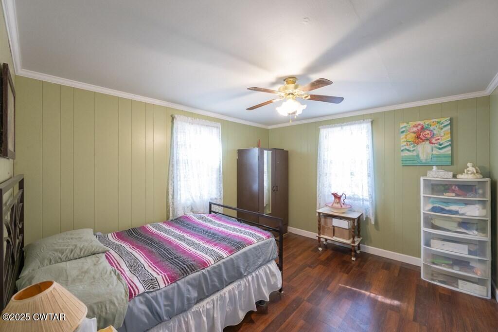 8405 Highway 77 Huntingdon, TN 38344 - Photo 4 of 37 a bedroom with a bed a dresser and wooden floor