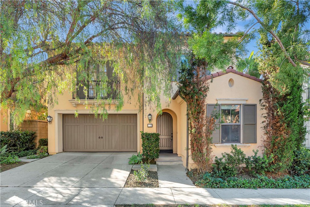 110 Mosswood Irvine, CA 92620 - Photo 1 of 38 a front view of a house with a yard and garage