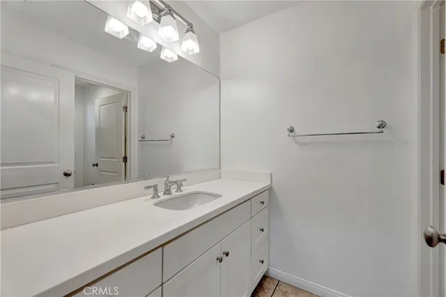 a bathroom with a sink vanity and a mirror