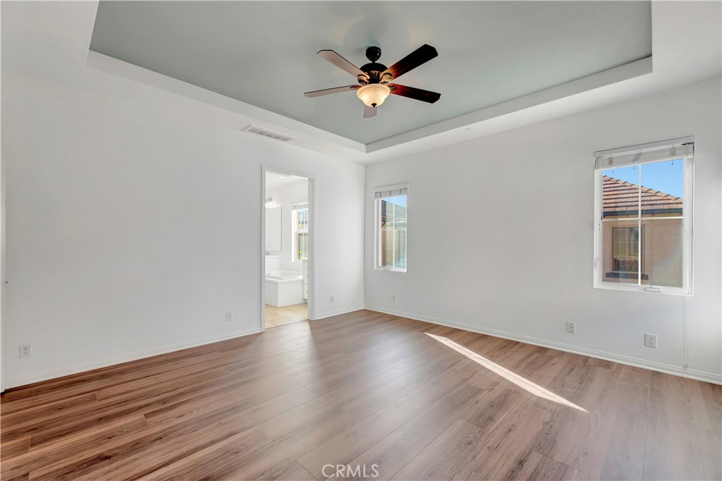 110 Mosswood Irvine, CA 92620 - Photo 16 of 38 an empty room with wooden floor and ceiling fan