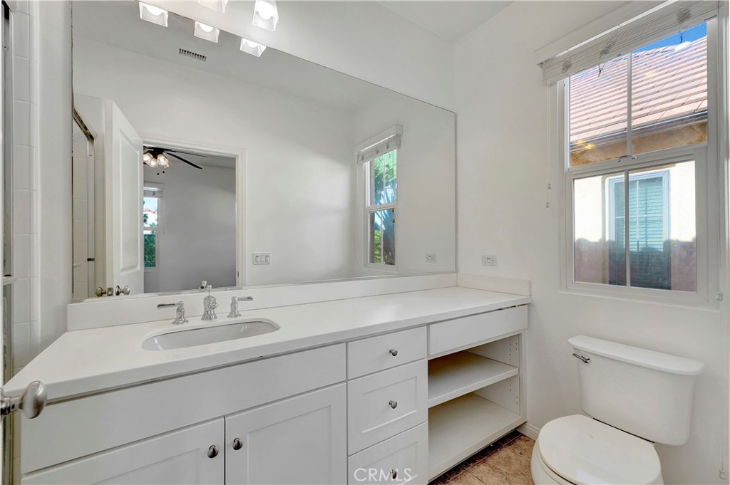 110 Mosswood Irvine, CA 92620 - Photo 21 of 38 a bathroom with a toilet a sink and mirror