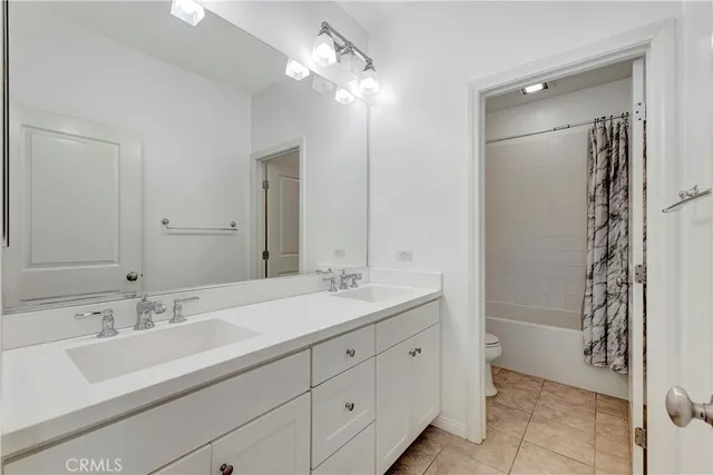 a bathroom with a sink double vanity and a mirror
