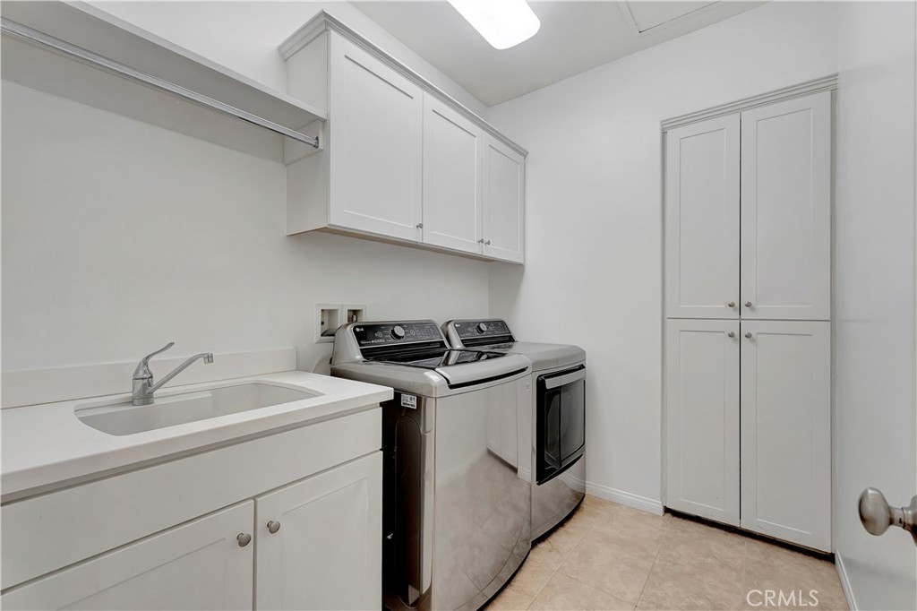 110 Mosswood Irvine, CA 92620 - Photo 26 of 38 a utility room with sink dryer and washer