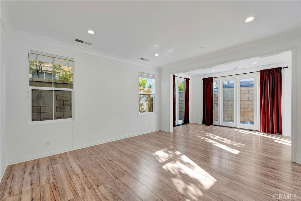 110 Mosswood Irvine, CA 92620 - Photo 3 of 38 a view of an empty room with wooden floor and a window