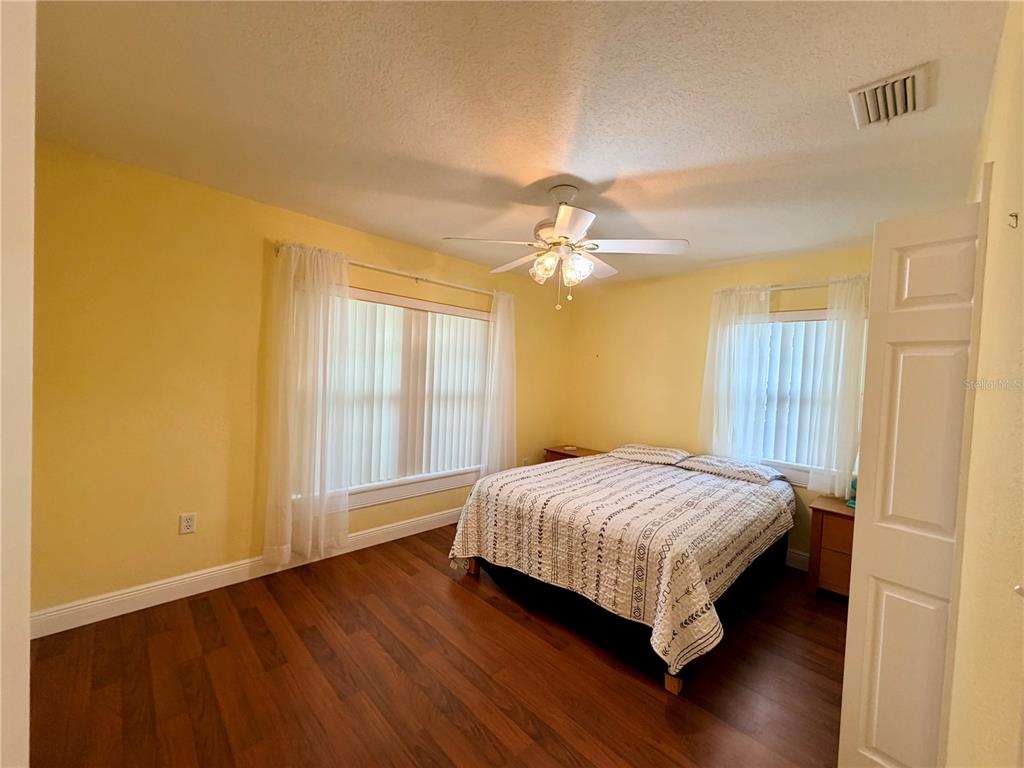 1020 2nd Avenue Northwest Largo, FL 33770 - Photo 12 of 37 a bedroom with a bed and wooden floor