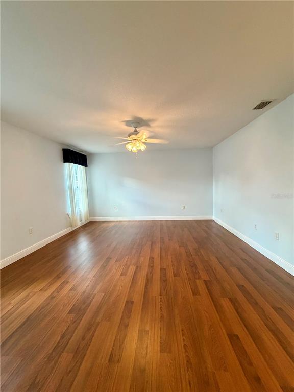 1020 2nd Avenue Northwest Largo, FL 33770 - Photo 17 of 37 an empty room with wooden floor and windows