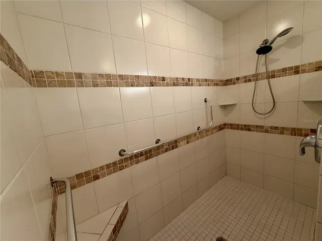 a bathroom with a toilet sink vanity granite and a mirror
