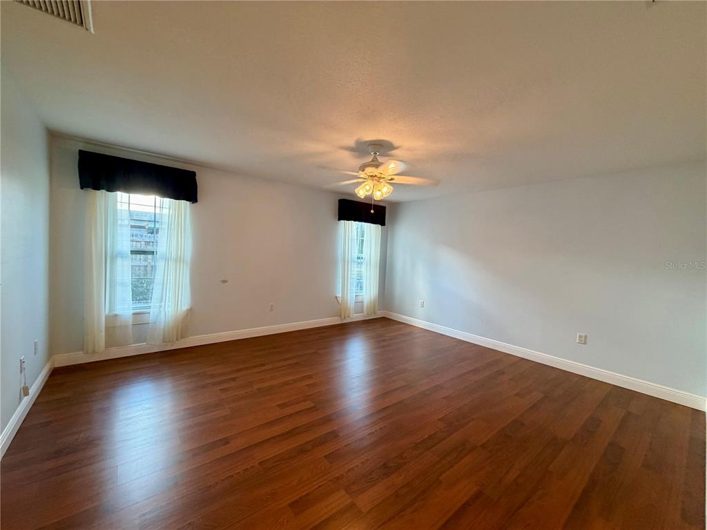 1020 2nd Avenue Northwest Largo, FL 33770 - Photo 21 of 37 a view of an empty room with wooden floor and a window