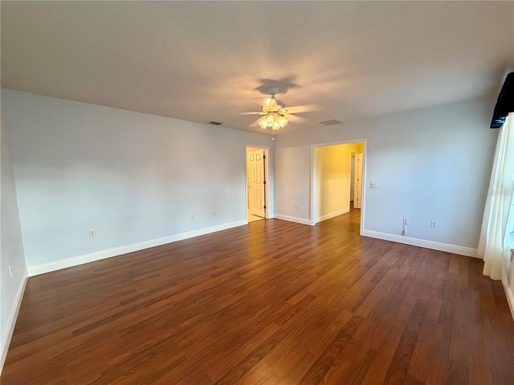 1020 2nd Avenue Northwest Largo, FL 33770 - Photo 22 of 37 an empty room with wooden floor and windows