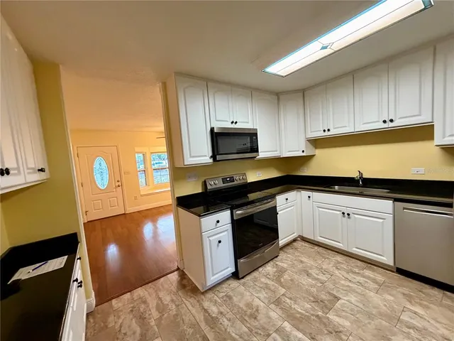 a kitchen with a sink a stove and refrigerator