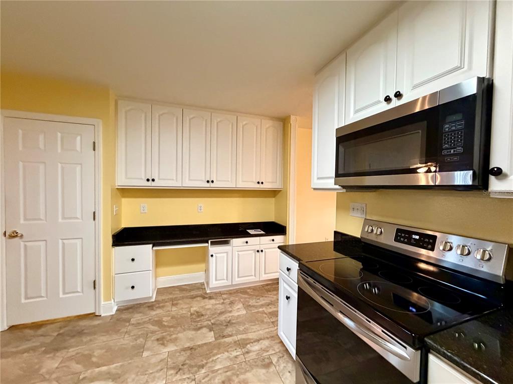 1020 2nd Avenue Northwest Largo, FL 33770 - Photo 26 of 37 a kitchen with stainless steel appliances a stove a microwave and cabinets