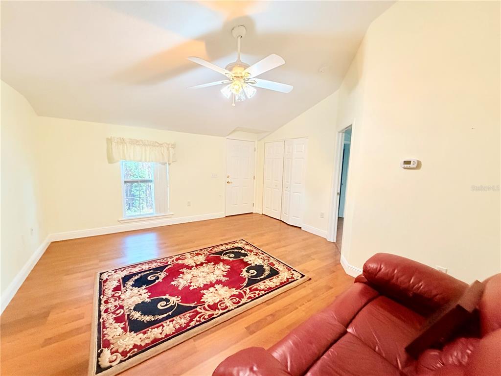 1020 2nd Avenue Northwest Largo, FL 33770 - Photo 31 of 37 a bedroom with a bed and wooden floor