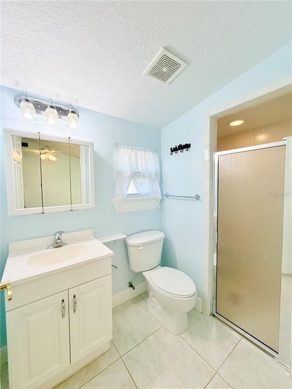 1020 2nd Avenue Northwest Largo, FL 33770 - Photo 34 of 37 a bathroom with a sink a toilet a mirror and shower