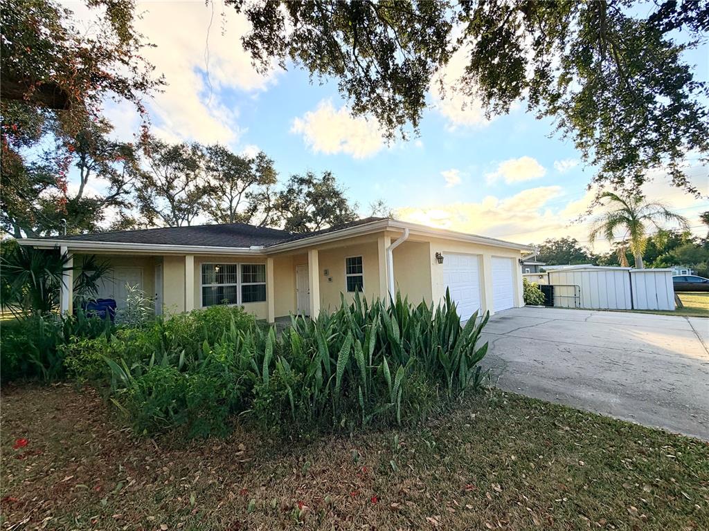 1020 2nd Avenue Northwest Largo, FL 33770 - Photo 4 of 37 a view of a yard in front of a house with plants and large tree