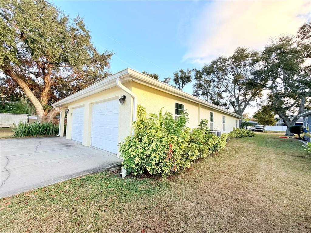 1020 2nd Avenue Northwest Largo, FL 33770 - Photo 5 of 37 a front view of a house with a yard and garage