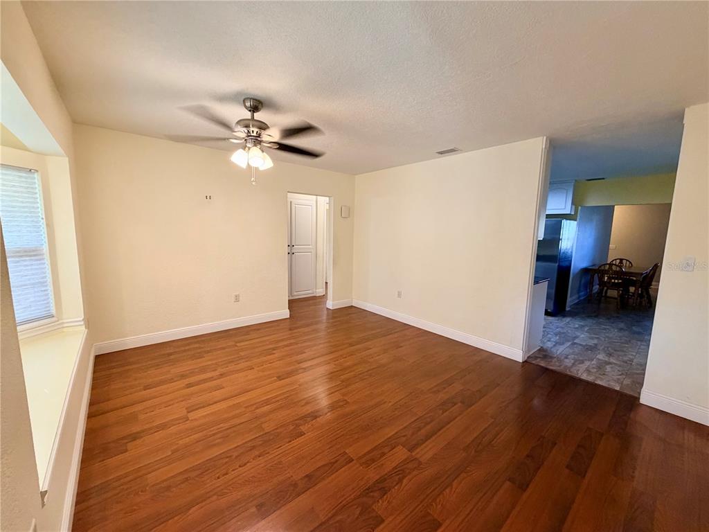 1020 2nd Avenue Northwest Largo, FL 33770 - Photo 8 of 37 a view of a room with wooden floor and a ceiling fan