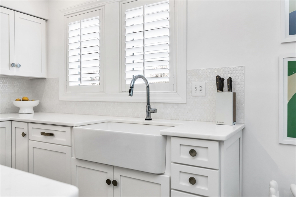 6 Summer Street, Unit D Manchester, MA 01944 - Photo 13 of 31 a kitchen with cabinets appliances a sink and a window