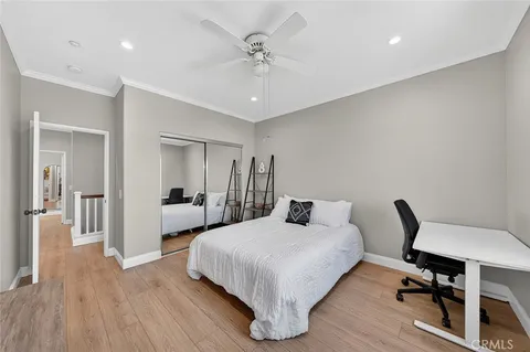 a bedroom with a bed and a desk
