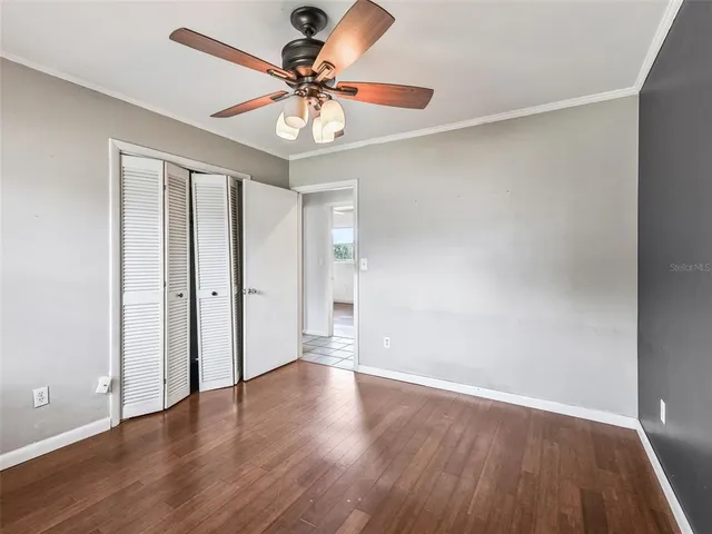 a view of an empty room with wooden floor