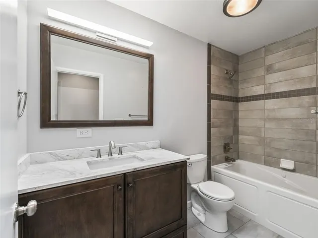 a bathroom with a toilet a sink a bathtub and a mirror