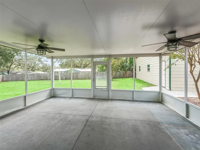 a view of a room with wooden floor and windows