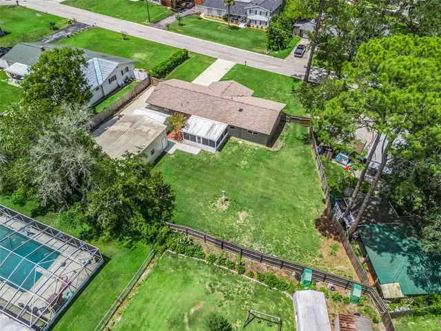 an aerial view of a house with a garden and trees