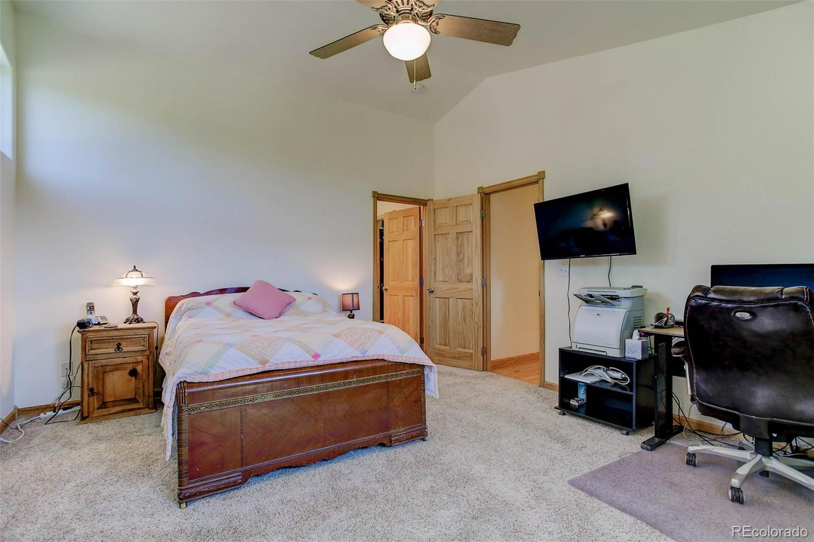 29 Pine Trail Bailey, CO 80421 - Photo 12 of 30 a bedroom with a bed and a flat screen tv