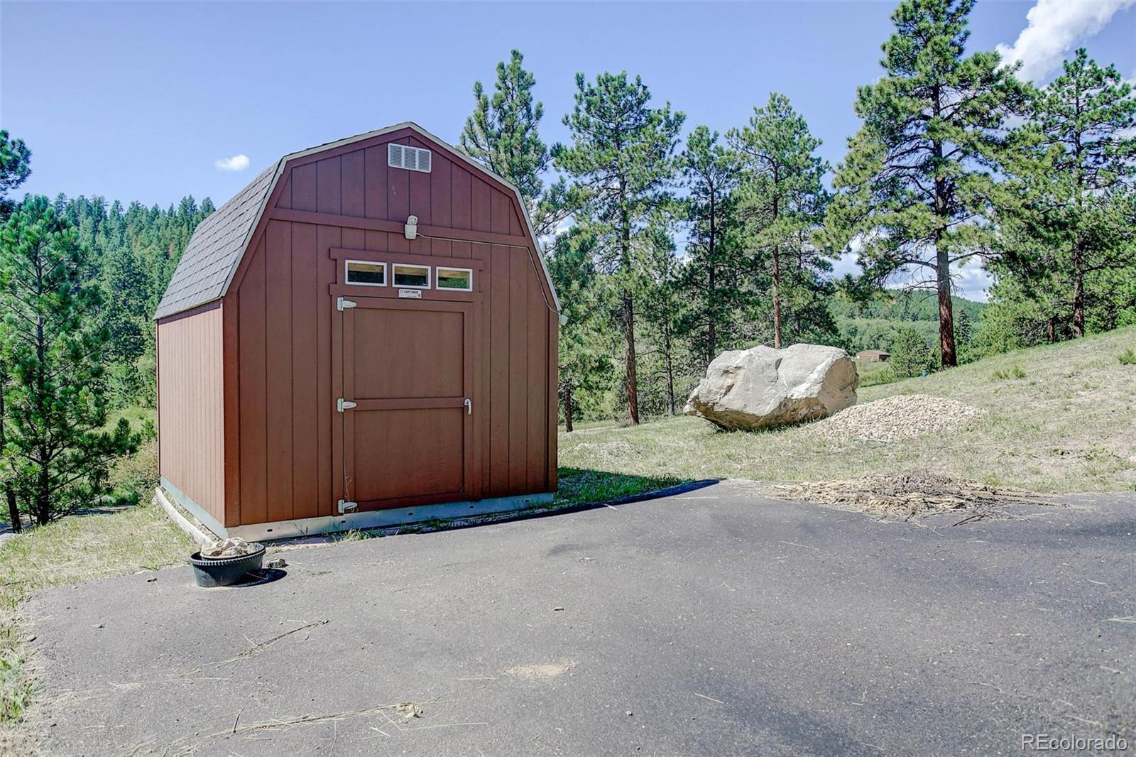 29 Pine Trail Bailey, CO 80421 - Photo 4 of 30 a front view of a house with a yard