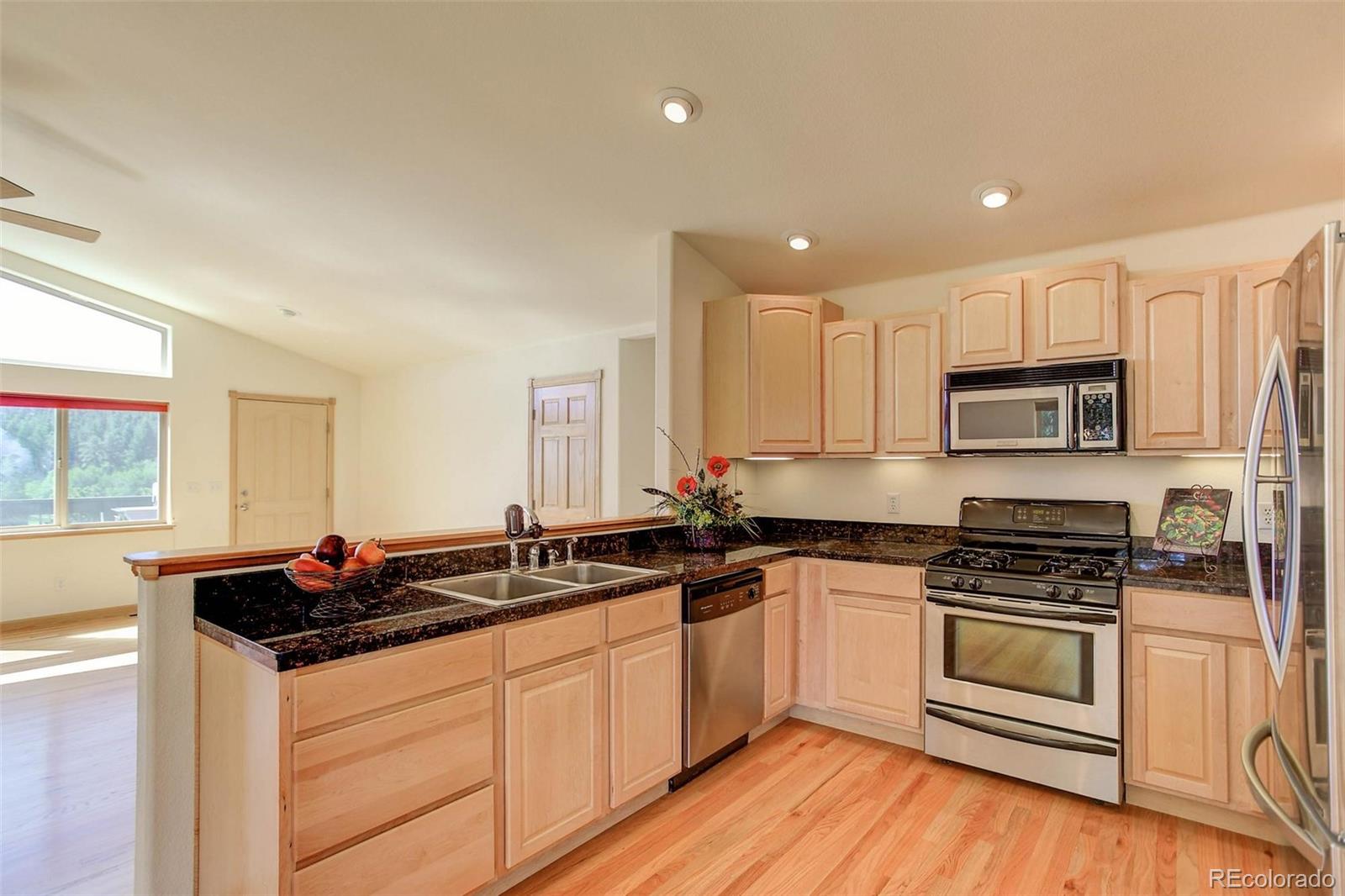 29 Pine Trail Bailey, CO 80421 - Photo 8 of 30 a kitchen with granite countertop a sink cabinets and stainless steel appliances