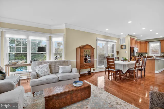 a living room with furniture dining table and a large window