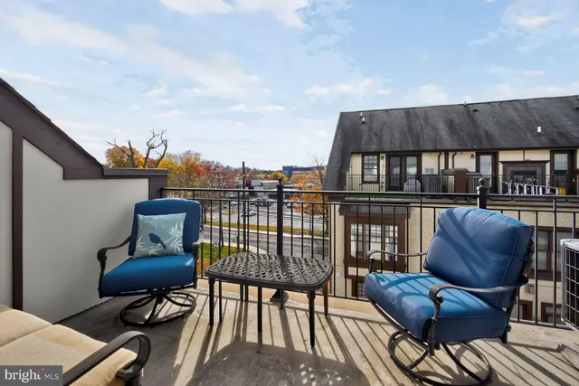 a balcony with table and chairs