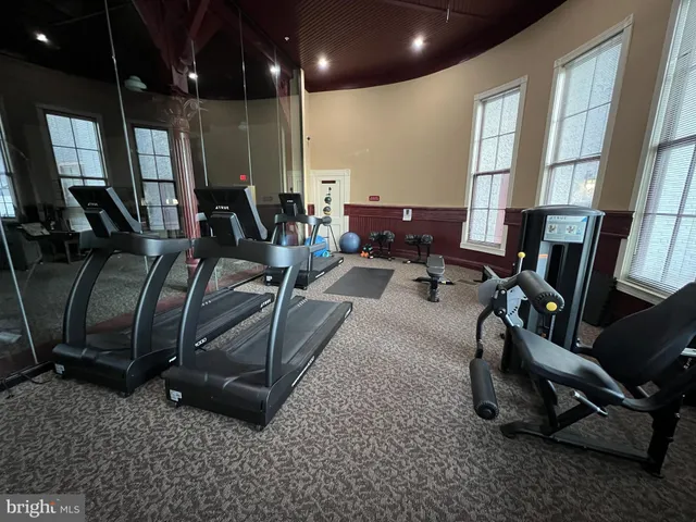 a room with gym equipment and a large window