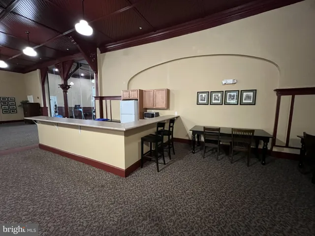 a view of an empty room with furniture and a garage