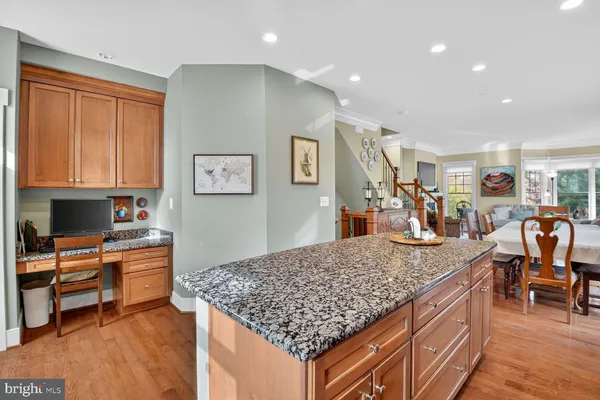 a view of living room kitchen with stainless steel appliances granite countertop cabinets and rug