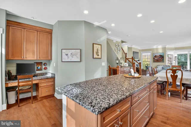 a view of living room kitchen with stainless steel appliances granite countertop cabinets and rug