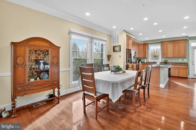 a view of a a dining room with furniture window and wooden floor