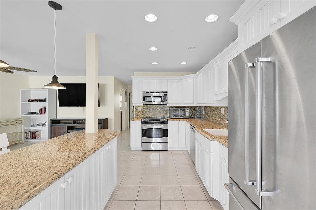 1110 North Riverside Drive, Unit 14 Pompano Beach, FL 33062 - Photo 19 of 56 This in one of the few Open Kitchens in the building which lends itself to Great Entertaining. Your 1st Floor Unit Features an Updated and Open Kitchen with Stainless Steel Appliances, Granite Countertops and a Snack Bar with Extra Cabinet Storage. Your Kitchen opens to POOLSIDE VIEWS! Welcome Home!